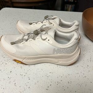 Tan colored Hoka transport shoe.